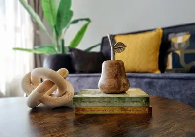 a table with two wooden objects on top at Ika Apartment Central in Burgas City