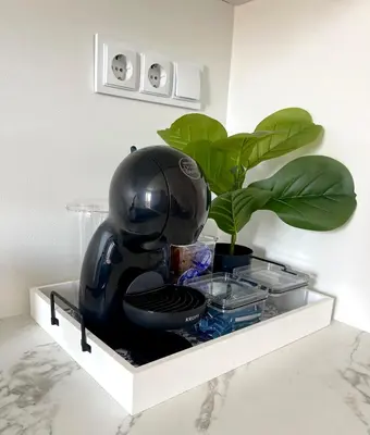 a black helmet sitting on a shelf with a plant at Marea Garden Apartment Ravda in Ravda