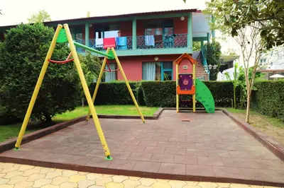 a playground in front of a house at Jasmine - Menada Apartments in Sunny Beach