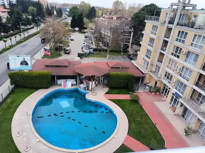 an overhead view of a swimming pool in front of a building at PSB Apartment in Flores park in Sunny Beach