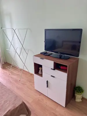 a entertainment center with a tv on top of it at PanoramaView Lazur in Burgas City