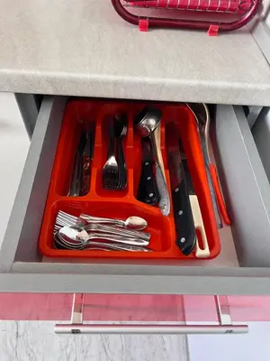 an orange tray of utensils in a drawer at PanoramaView Lazur in Burgas City