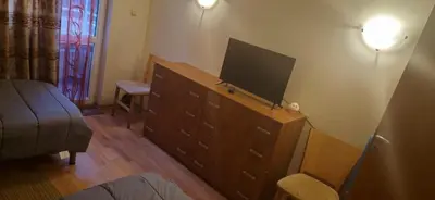 a bedroom with a dresser with a flat screen tv on it at Charming 2-bed Apartment with AC, 5 Mins from Beach in Sunny Beach