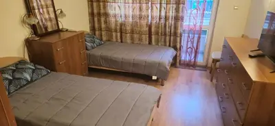 a bedroom with a bed and a dresser and a window at Charming 2-bed Apartment with AC, 5 Mins from Beach in Sunny Beach