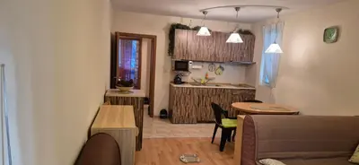 a living room with a couch and a table and a kitchen at Charming 2-bed Apartment with AC, 5 Mins from Beach in Sunny Beach