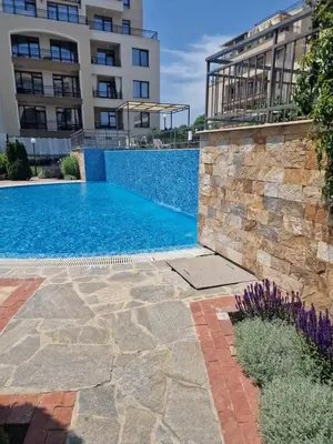 a swimming pool in front of a building at Sorrento Sole Mare Sveti Vlas in Sveti Vlas