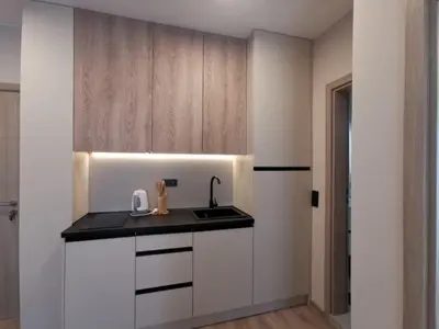 a kitchen with white cabinets and a sink at Sorrento Sole Mare Sveti Vlas in Sveti Vlas