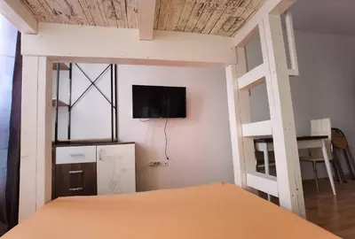 a bedroom with a bunk bed with a tv on the wall at Family Studio flat in Tŭnkovo