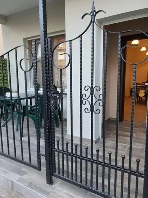 a black wrought iron fence in front of a house at Студио Морски бриз in Pomorie