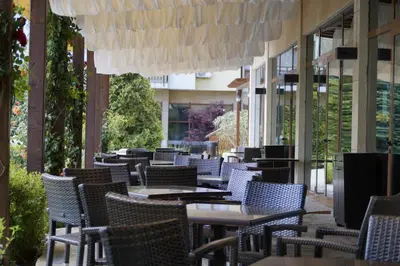 a row of tables and chairs on a patio at Аpartment in the Garden of Eden in Sveti Vlas