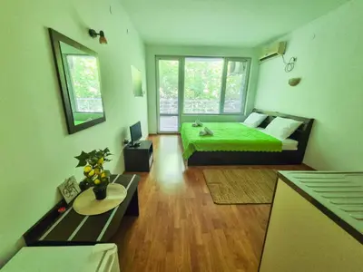 a bedroom with a green bed and a window at NeV Getaway for 2 in Burgas City