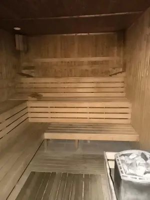 a sauna with a wooden bench in a room at Villa ROMA apartaments&SPA in Nesebar