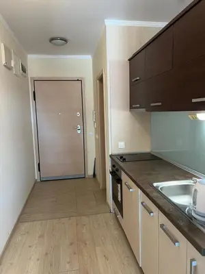 a kitchen with a sink and a door to a hallway at Villa ROMA apartaments&SPA in Nesebar