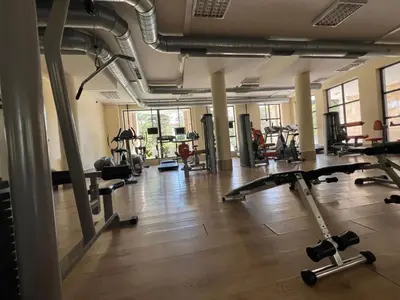 a gym with a lot of treadmills and machines at Villa ROMA apartaments&SPA in Nesebar