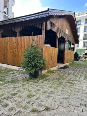 a wooden building with a plant in front of it at Passat12 in Sunny Beach