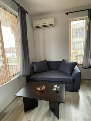 a living room with a couch and a coffee table at Adagio Sarafovo in Burgas City