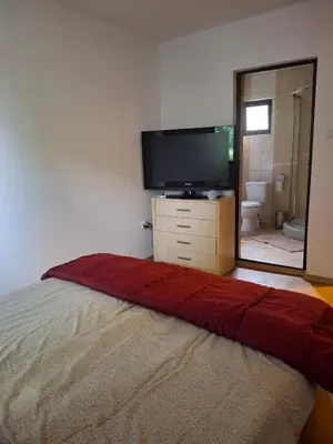 a bedroom with a flat screen tv and a bed at The Byala Escape, Private Villa with Bar & Hot Tub in Byala