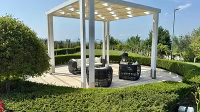 a gazebo with a couch and chairs on a patio at Апартамент Панорама, двустаен, малък, първа линия, гледка море, DIAMOND BEACH, Сарафово in Burgas City