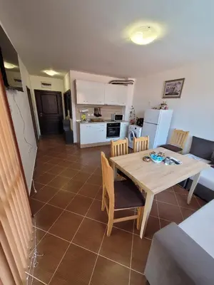 a kitchen and dining room with a table and chairs at Famagusta Antoniya in Aheloy
