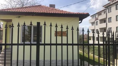 a black fence in front of a house at Вила НАДЕЖДА in Byala