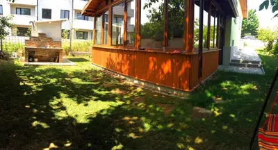 a house in a yard with a grassy yard with a building at Вила НАДЕЖДА in Byala