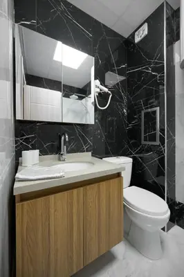 a bathroom with a toilet and a sink and a mirror at Azur Properties ap50 in Shkorpilovtsi