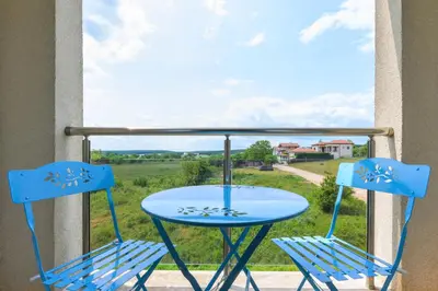 a table and two chairs on a balcony with a view at Azur Properties ap50 in Shkorpilovtsi