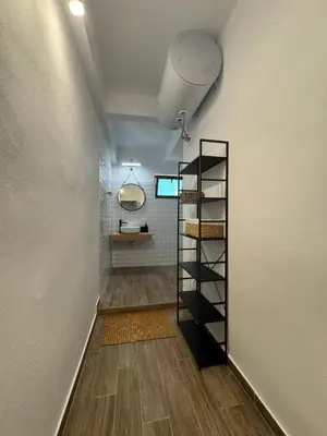 a hallway with a shelf in a bathroom at Studio by the sea in Primorsko