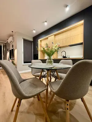 a dining room with a table and chairs and a kitchen at Апартамент Vista Al Mar in Pomorie