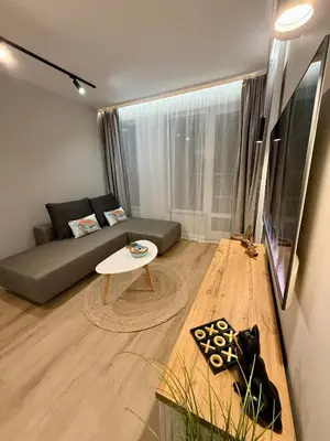 a living room with a couch and a table at Апартамент Vista Al Mar in Pomorie