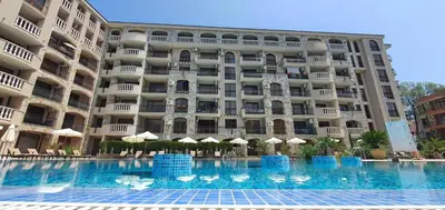 a large building with a swimming pool in front of it at Kalia D11 Słoneczny Brzeg Sunny Beach in Sunny Beach