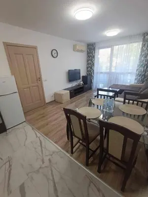 a living room with a table and chairs and a couch at Kalia D11 Słoneczny Brzeg Sunny Beach in Sunny Beach