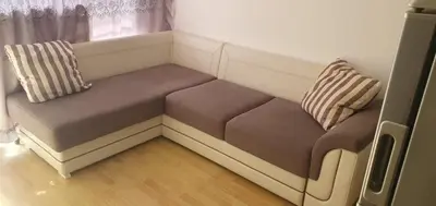 a couch with two pillows sitting in a room at Квартира студия Villa Astoria 2 Болгария Солнечный берег in Elenite