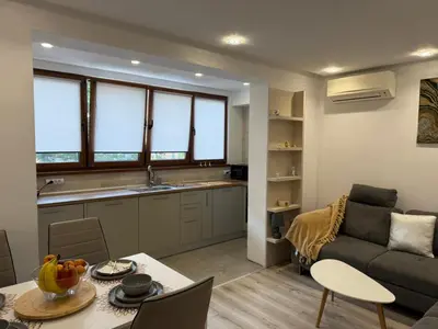 a kitchen and living room with a couch and a table at Lazzuro 7 in Burgas City