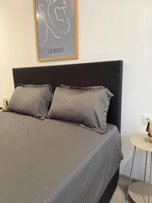 a bed with two pillows on it in a room at Lazzuro 7 in Burgas City