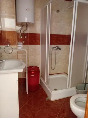 a bathroom with a shower and a sink and a toilet at Imperial Fort Club in Sveti Vlas