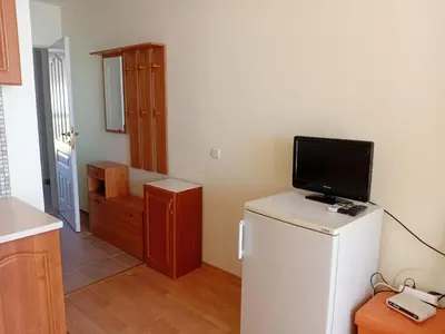a kitchen with a tv on top of a refrigerator at Imperial Fort Club in Sveti Vlas