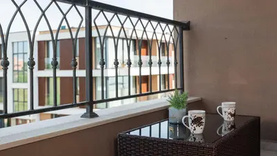 a balcony with a table and two mugs on it at Sea Holiday 21 in Burgas City