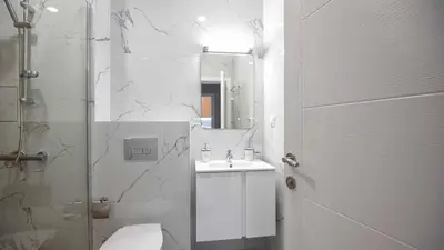 a bathroom with a toilet and a sink and a shower at Sea Holiday 21 in Burgas City