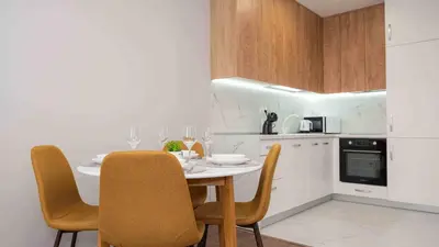 a kitchen with a table and chairs in a kitchen at Sea Holiday 21 in Burgas City