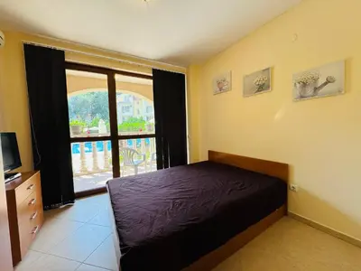 a bedroom with a bed and a large window at KALIA C2 Two Bedroom Apartment Sunny Beach in Sunny Beach