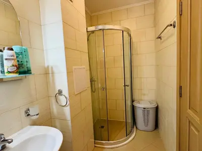 a shower in a bathroom with a sink and a toilet at KALIA C2 Two Bedroom Apartment Sunny Beach in Sunny Beach