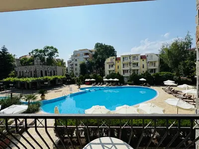a view of a swimming pool with umbrellas and chairs at KALIA C4 One Bedroom Apartment Sunny Beach in Sunny Beach