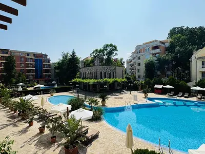 a large swimming pool with chairs and umbrellas at KALIA C4 One Bedroom Apartment Sunny Beach in Sunny Beach