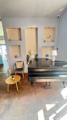 a living room with a piano and a table at Sunny Beach Vila in Sunny Beach
