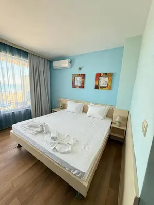 a large bed in a room with blue walls at Sunny Beach Vila in Sunny Beach