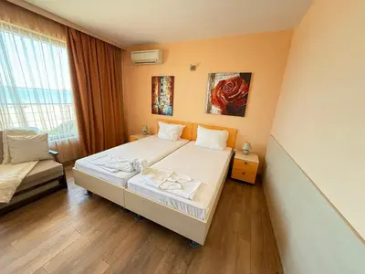 a small bedroom with a bed and a window at Sunny Beach Vila in Sunny Beach