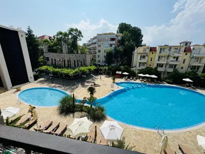 an overhead view of a swimming pool with chairs and umbrellas at KALIA C9 One Bedroom Apartment in Sunny Beach