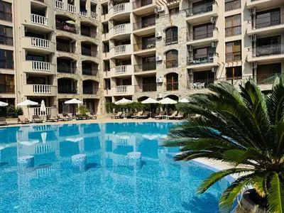a swimming pool in front of a large apartment building at KALIA C9 One Bedroom Apartment in Sunny Beach