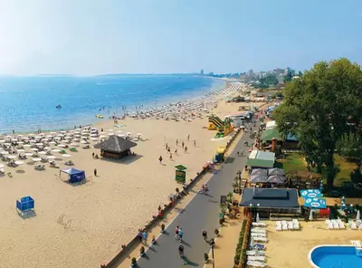 a beach with a lot of umbrellas and people on it at KALIA C9 One Bedroom Apartment in Sunny Beach